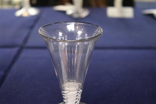 An 18th century firing glass, c.1760, with flared rim bowl and gauze column, encircled by twist opaque stem, 4.5in.